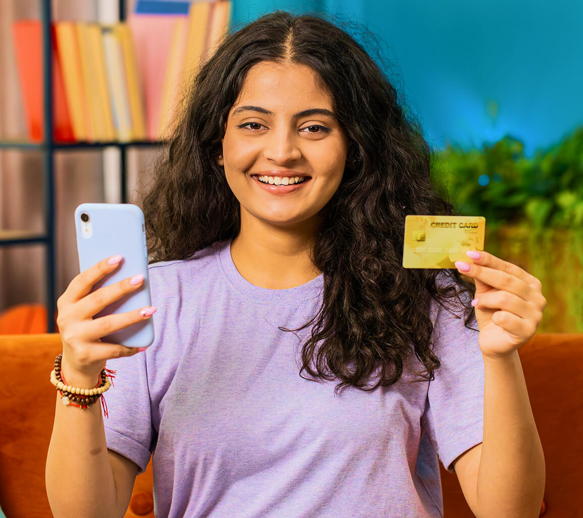Customer holding her bank card and phone